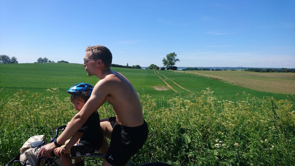 Dad cycling with son