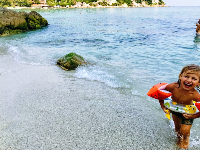 Kid Playing on the beach at Shark Bay on Koh Tao