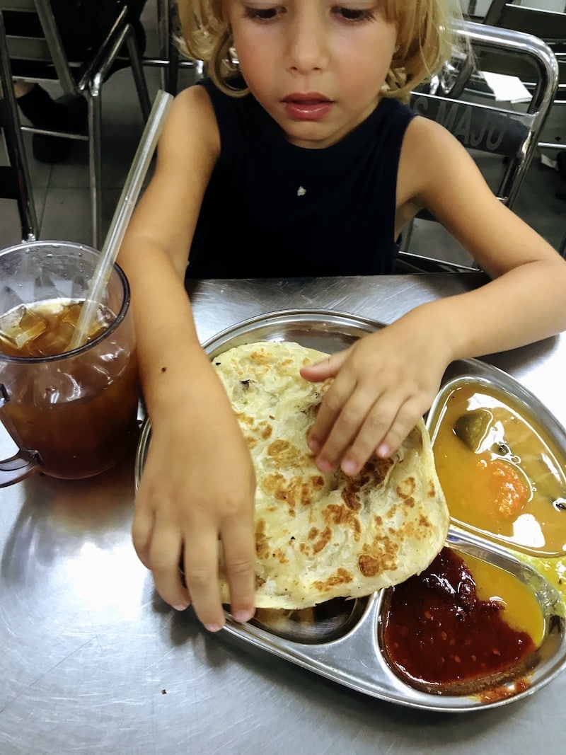 Kid eating Roti