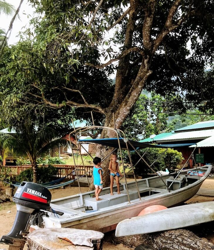 Kids playing at old speedboat